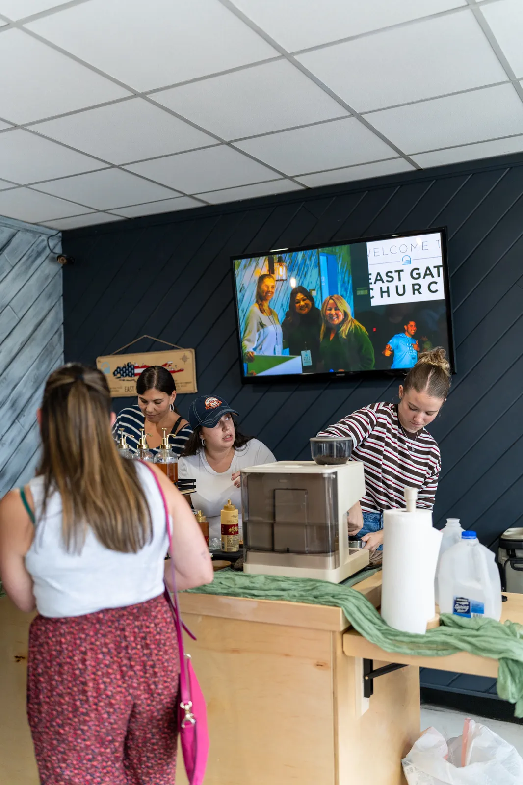 A guest orders at the cart as a barista works behind the counter.